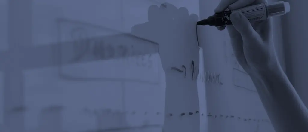 Hand sketching a process on a whiteboard