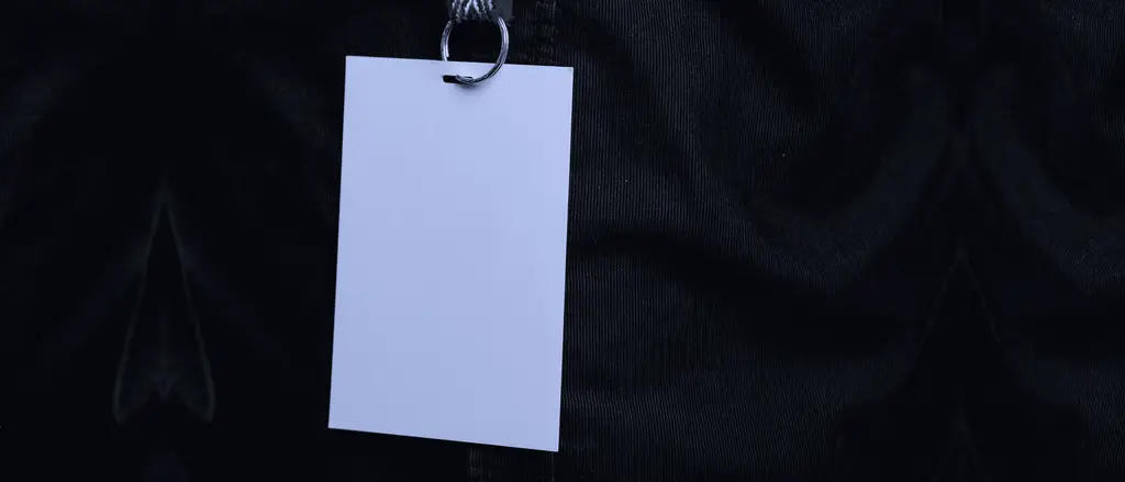 Blank employee badge on a lanyard against a dark shirt
