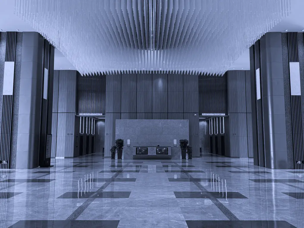 Marble lobby of an office tower with a reception desk
