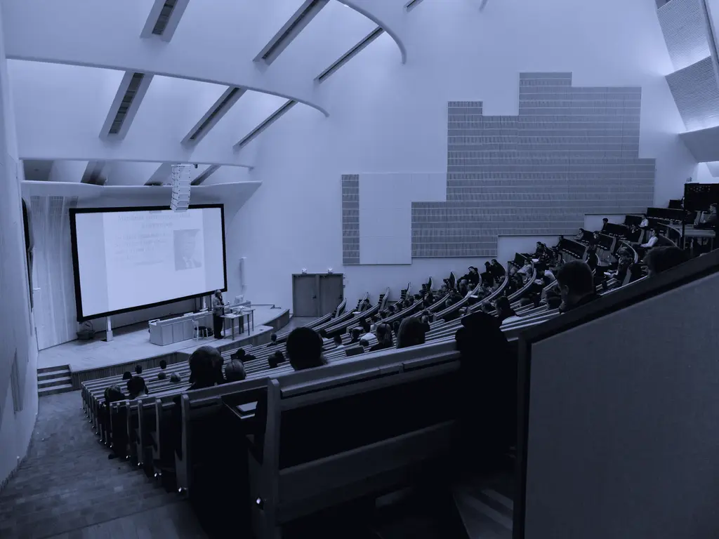 Lecture hall with students facing a projection screen